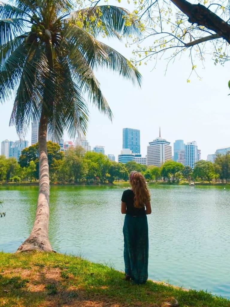 Girl beside palm tree in Lumphini Park 