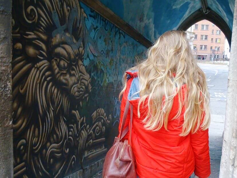 Girl looking at lion street art Bristol